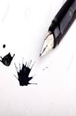 13725113-Two-messy-black-ink-splats-with-fountain-pen-opened-to-show-the-nib-on-white-paper-Stock-Photo.jpg