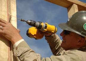 US_Navy_061125-N-6889J-033_Builder_3rd_Class_Mathew_Speece_of_Naval_Mobile_Construction_Battalion_Seven_Four_(NMCB-74)_secures_the_frame_of_a_wall_at_Camp_Ramadi.jpg