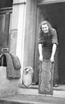 A woman cleans her doormat