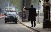 A man hails a London black-cab