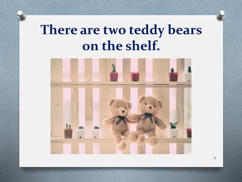 There are two teddy bears on the shelf